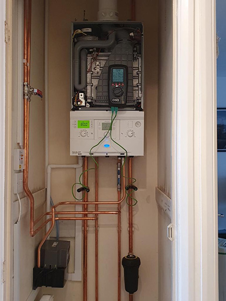 Heating programmer and controls being tested by an engineer